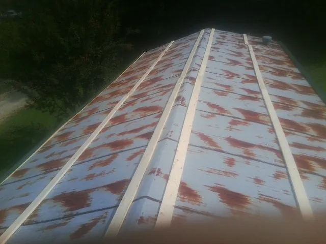 Rusted metal roof panels with new wood purlins before replacement — Storm Damage Roof Repair in Medinah by Roofing Brothers