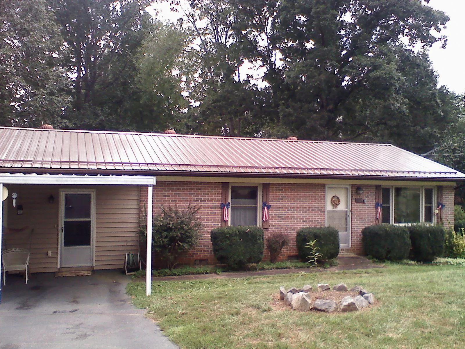 Bronze metal roof and carport on a brick ranch home — Roof Repair work by our crew in Medinah