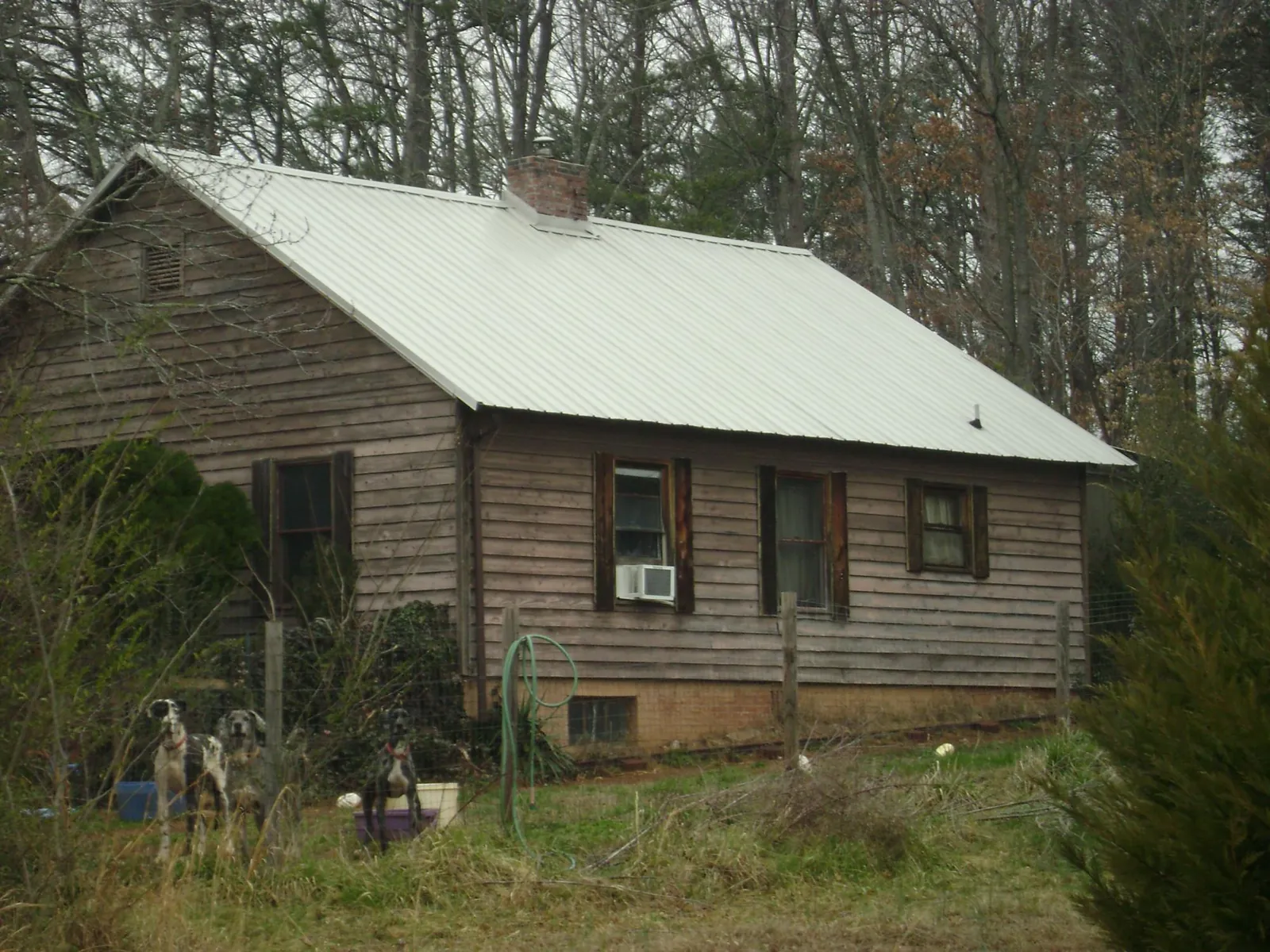 White metal roof on an old wood sided farmhouse, from a Metal Roof Installation job in Medinah